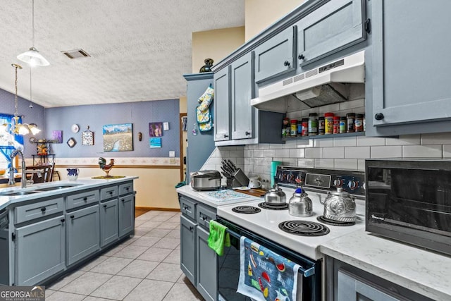 kitchen with visible vents, a sink, a textured ceiling, range with electric cooktop, and under cabinet range hood