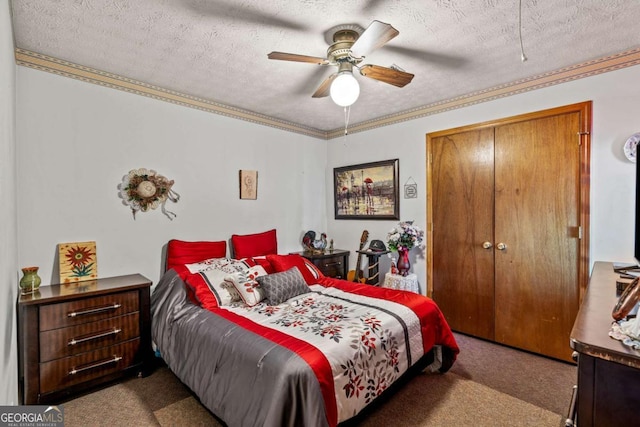 bedroom featuring carpet floors, a closet, ornamental molding, a ceiling fan, and a textured ceiling