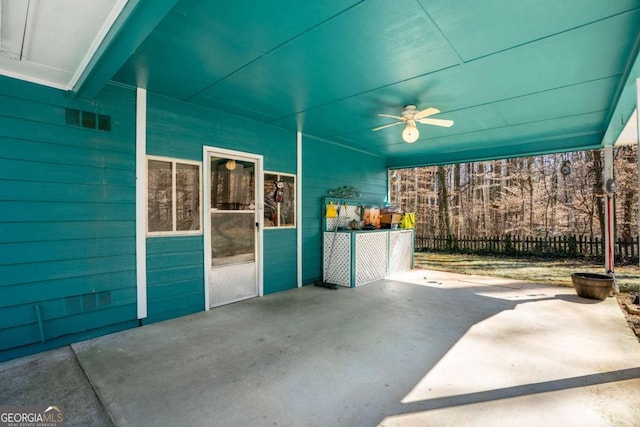 view of patio featuring ceiling fan and fence