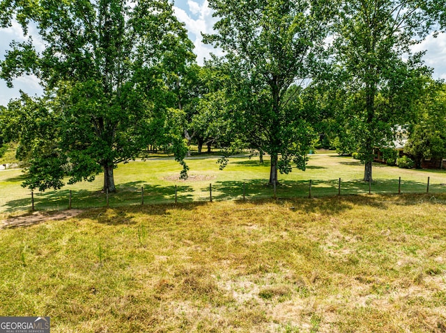 view of yard featuring a rural view and fence