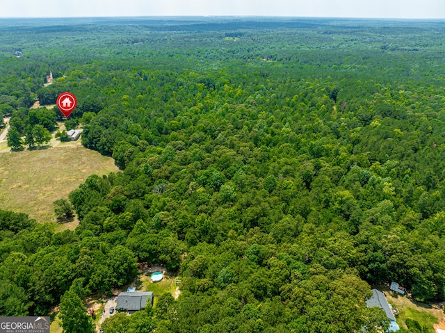 drone / aerial view featuring a forest view