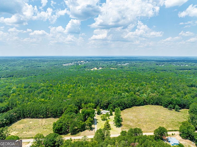 birds eye view of property with a view of trees