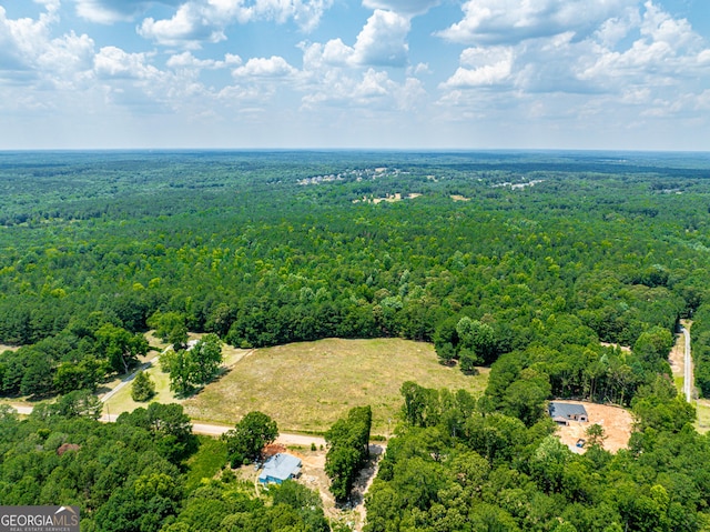 birds eye view of property featuring a wooded view