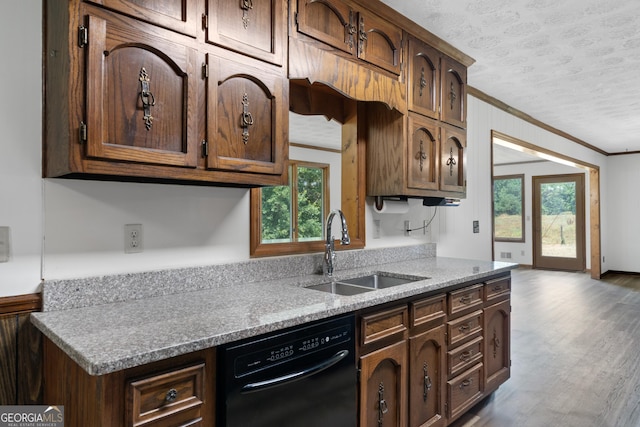 kitchen with a textured ceiling, wood finished floors, a sink, ornamental molding, and dishwasher