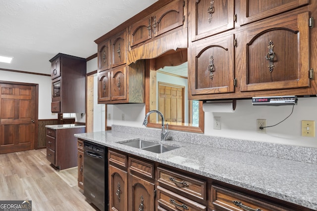 kitchen with a textured ceiling, a sink, black dishwasher, ornamental molding, and light wood-type flooring