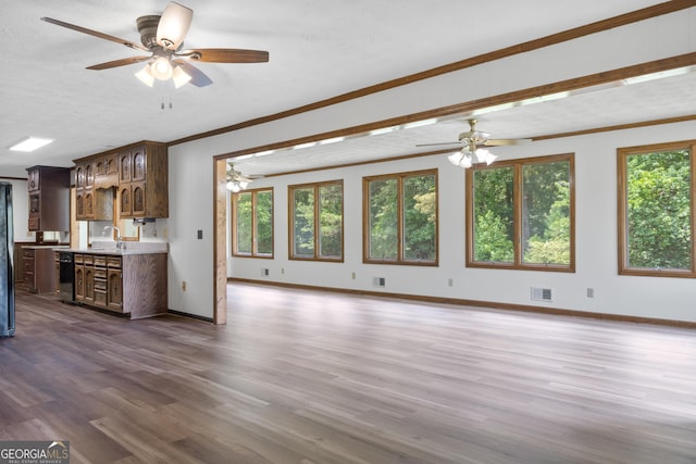 unfurnished living room featuring crown molding, visible vents, dark wood finished floors, and baseboards