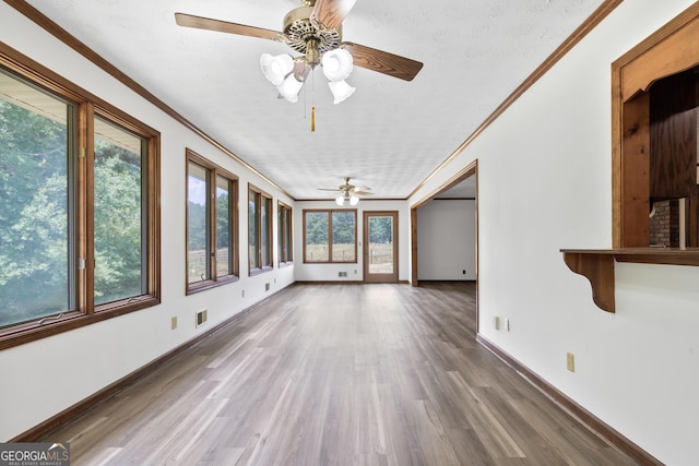 unfurnished sunroom featuring ceiling fan and visible vents