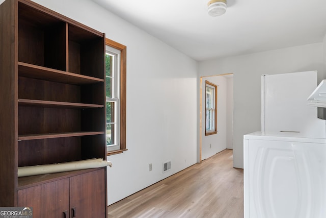 interior space featuring washer / clothes dryer, a healthy amount of sunlight, and laundry area