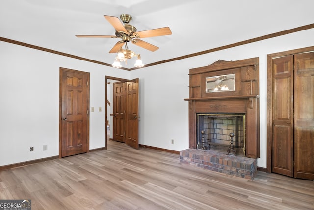 unfurnished living room with baseboards, a ceiling fan, ornamental molding, light wood-type flooring, and a brick fireplace