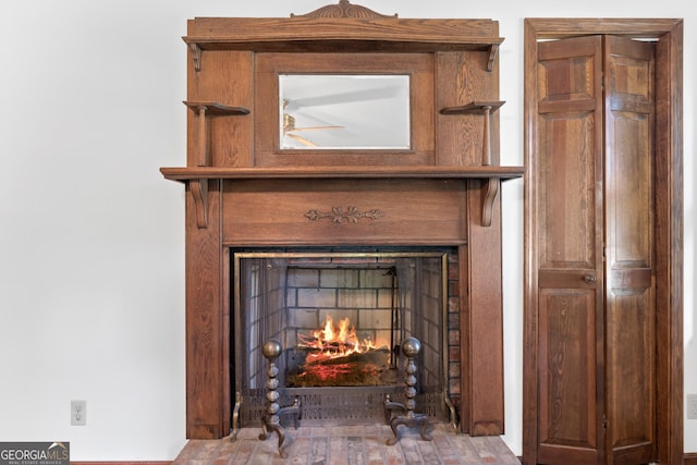 room details featuring a lit fireplace