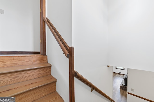 stairs featuring wood finished floors