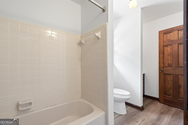 full bath featuring shower / bathing tub combination, wood finished floors, and toilet