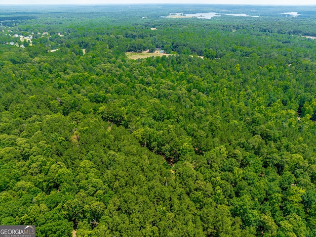 birds eye view of property with a view of trees