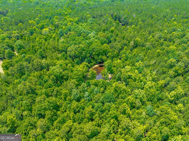 birds eye view of property with a view of trees