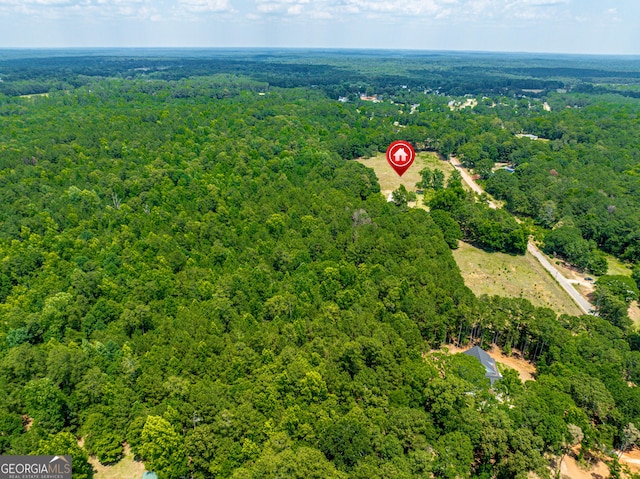 drone / aerial view featuring a view of trees