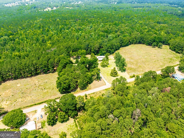 birds eye view of property featuring a wooded view