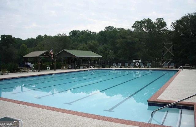 pool featuring a patio area and fence