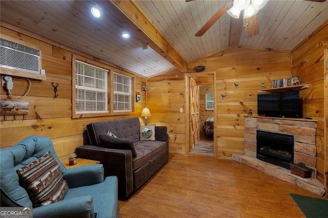 living area featuring vaulted ceiling with beams, wood walls, wooden ceiling, and wood finished floors