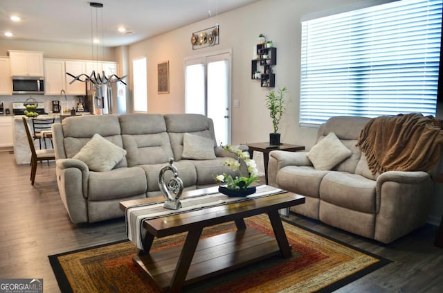 living room featuring a chandelier, wood finished floors, and recessed lighting