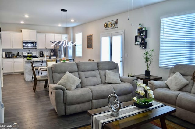 living room with recessed lighting and dark wood finished floors