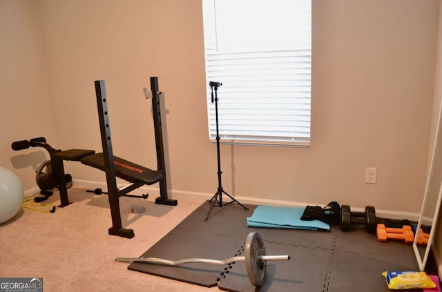 exercise room featuring carpet floors and baseboards