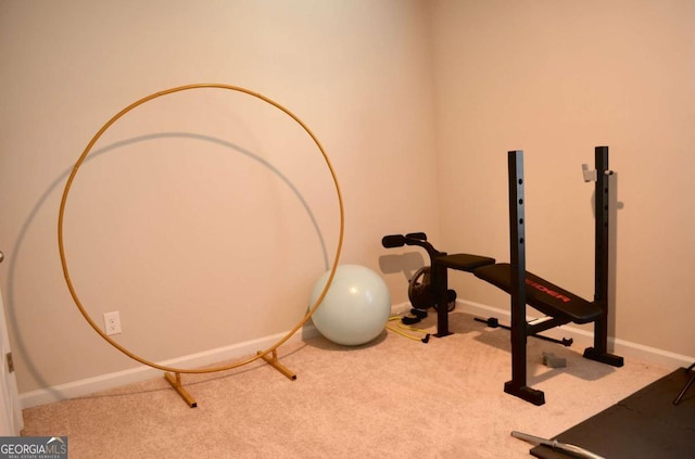 workout area featuring carpet flooring and baseboards