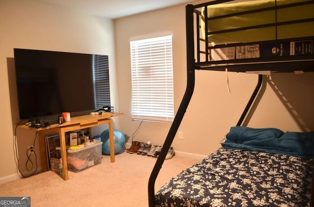 bedroom featuring multiple windows, carpet, and baseboards