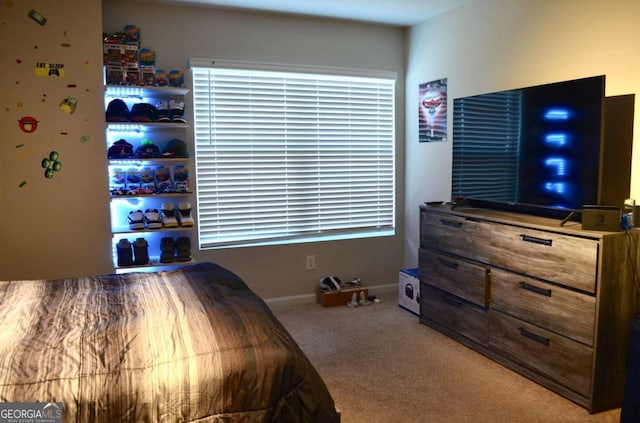 carpeted bedroom featuring baseboards