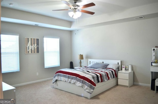 bedroom featuring visible vents, light carpet, and baseboards