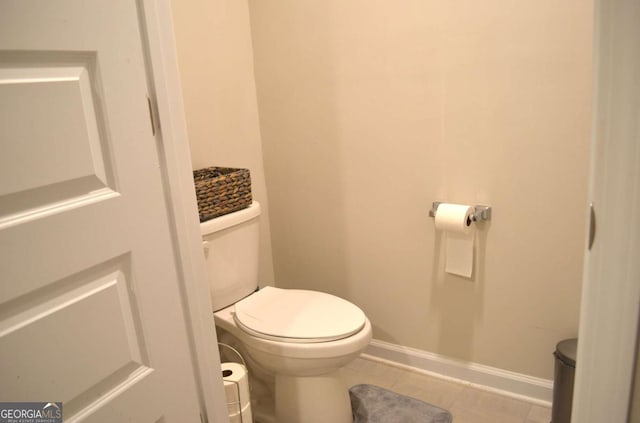 bathroom with toilet and baseboards