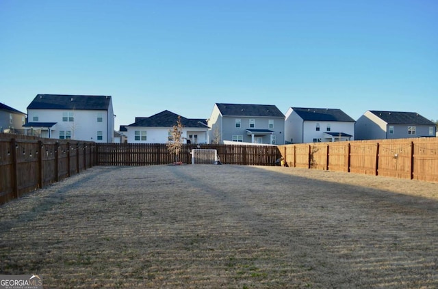 view of yard with a residential view and a fenced backyard