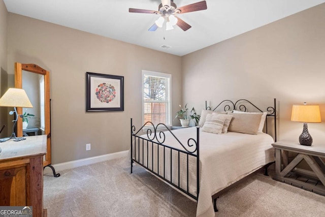 bedroom with light carpet, visible vents, baseboards, and a ceiling fan