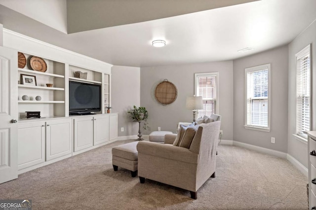 living room with baseboards and light colored carpet