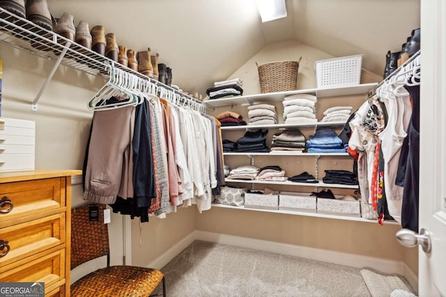 walk in closet featuring vaulted ceiling and carpet floors