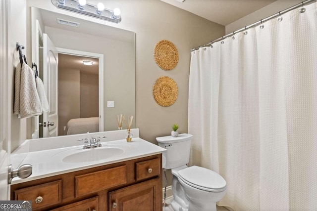 full bath featuring visible vents, vanity, and toilet