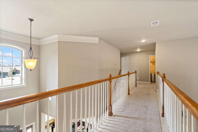 corridor with recessed lighting, light colored carpet, visible vents, baseboards, and ornamental molding