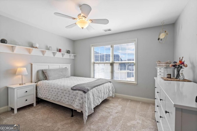 bedroom with a ceiling fan, visible vents, light carpet, and baseboards