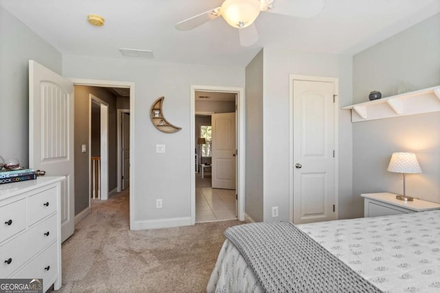 bedroom with baseboards, ceiling fan, and light colored carpet