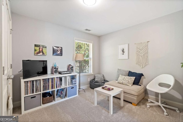 sitting room with carpet, visible vents, and baseboards