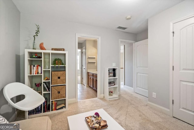 rec room featuring baseboards, light tile patterned floors, visible vents, and light colored carpet