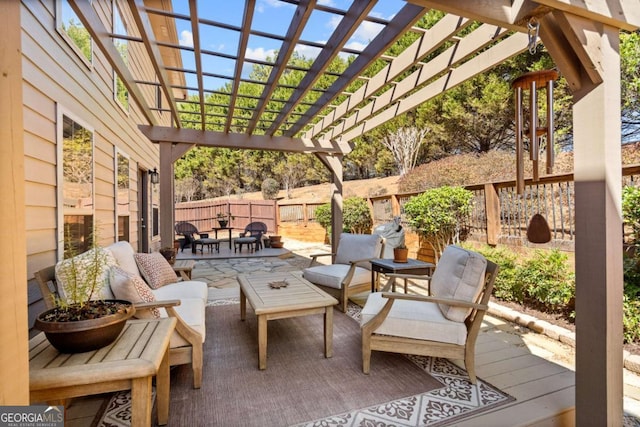 wooden deck featuring an outdoor hangout area, a patio, fence, and a pergola