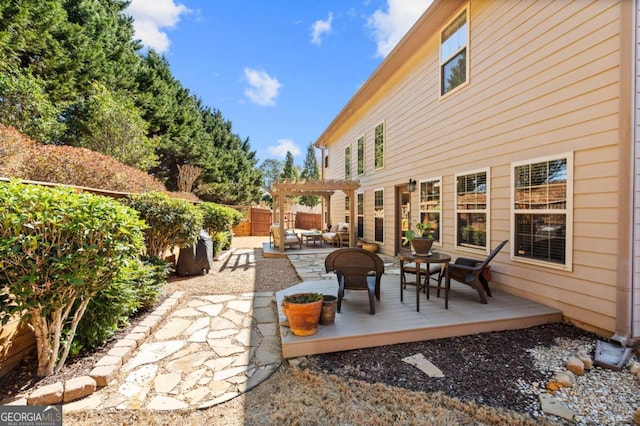 view of patio featuring fence, an outdoor hangout area, a wooden deck, and a pergola