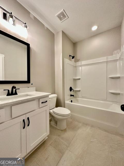 bathroom featuring toilet, visible vents, shower / bathing tub combination, and vanity