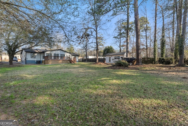 view of yard featuring an outbuilding and fence