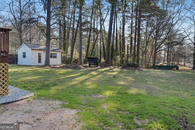 view of yard featuring an outbuilding and fence