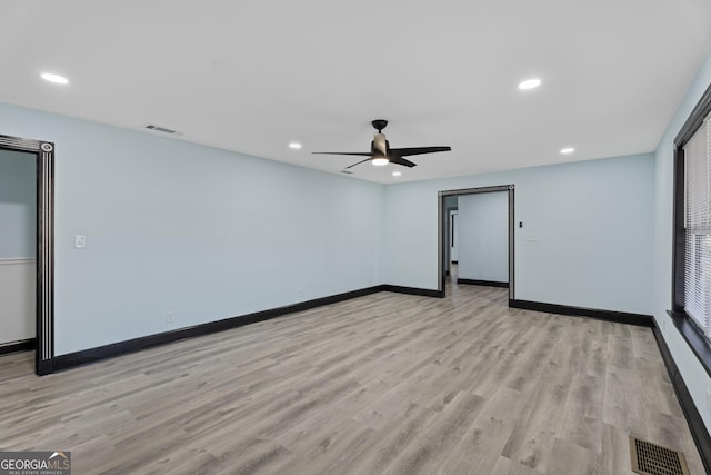 spare room with light wood-style floors, baseboards, visible vents, and recessed lighting