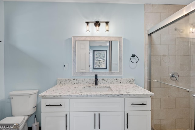 full bathroom with toilet, a shower stall, and vanity