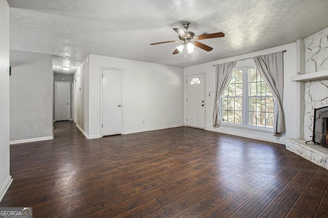 unfurnished living room with a ceiling fan, a fireplace, a textured ceiling, and hardwood / wood-style floors