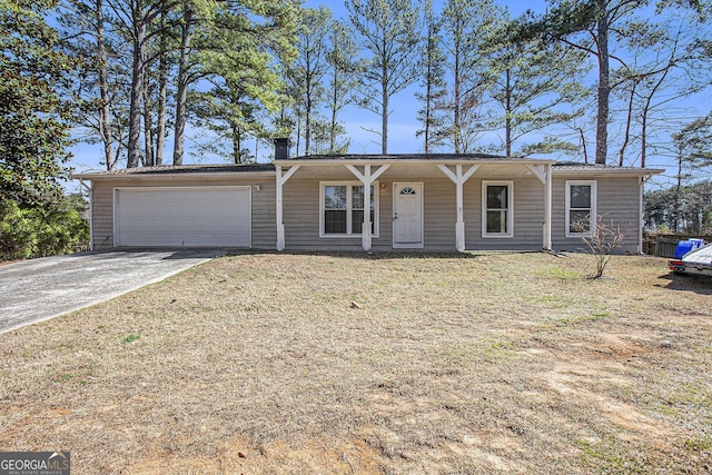 ranch-style house with an attached garage, concrete driveway, and a front yard