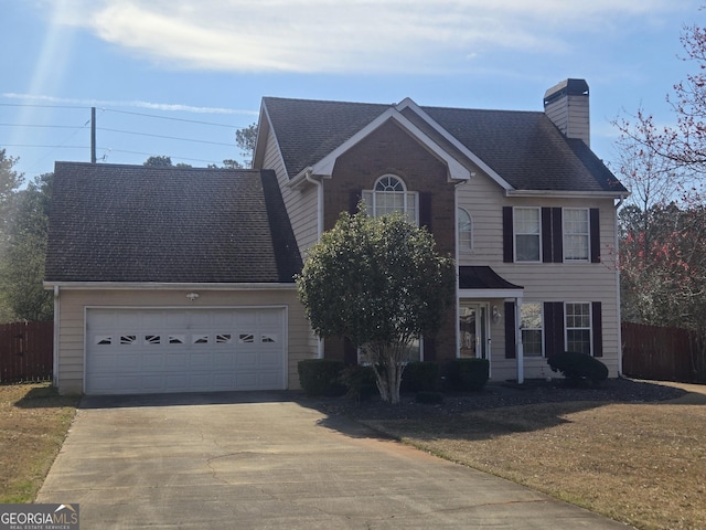 view of front facade featuring a chimney, an attached garage, concrete driveway, and fence